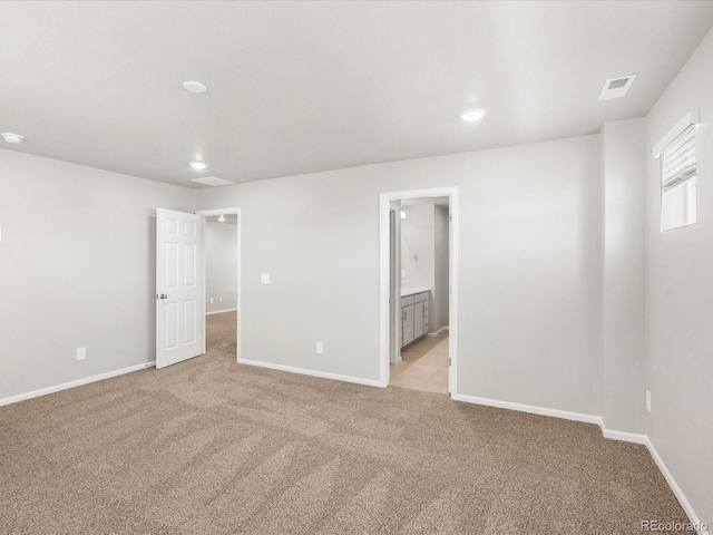 17487 E 89th Way, Commerce City, CO 80022 - unfurnished bedroom with light colored carpet, baseboards, recessed lighting, and connected bathroom
