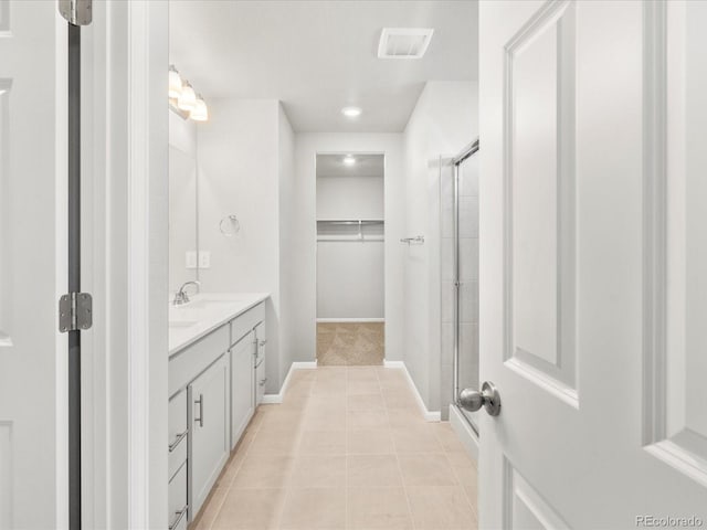 17487 E 89th Way, Commerce City, CO 80022 - full bath featuring vanity, a walk in closet, baseboards, a shower with door, and recessed lighting