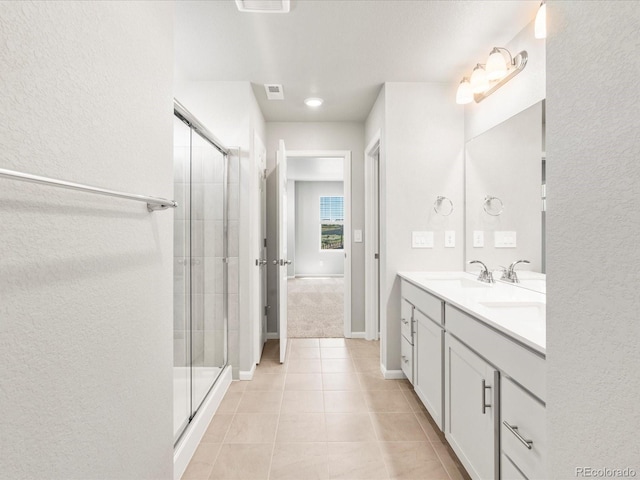 17487 E 89th Way, Commerce City, CO 80022 - bathroom featuring vanity, a shower stall, tile patterned floors, a textured wall, and baseboards