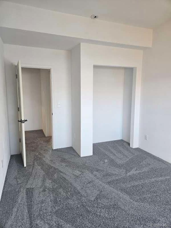 unfurnished bedroom with a closet and carpet