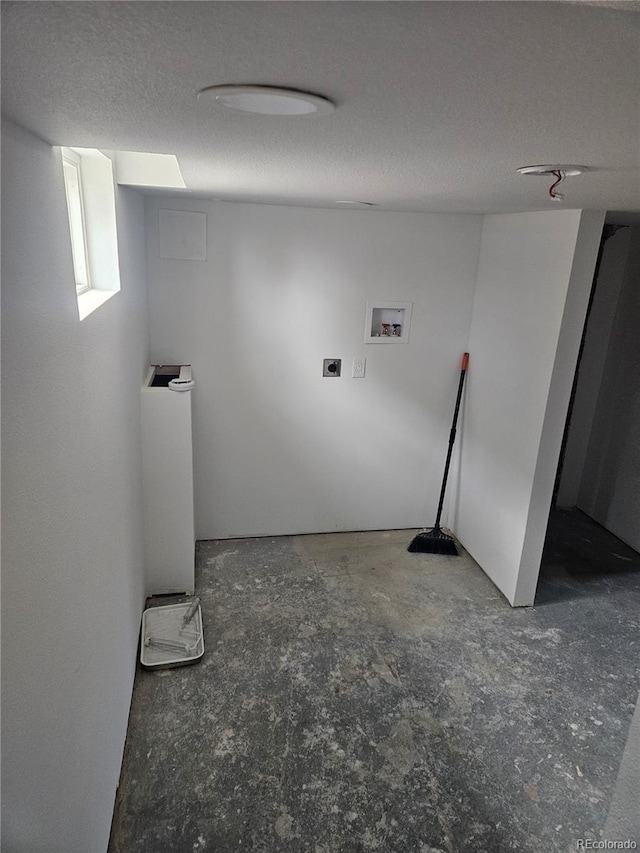 laundry area with washer hookup and a textured ceiling