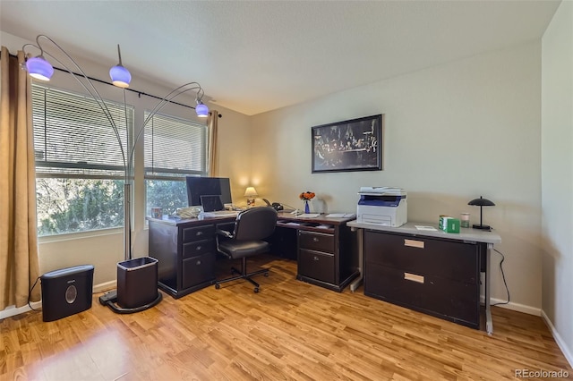 office featuring light wood-style flooring and baseboards