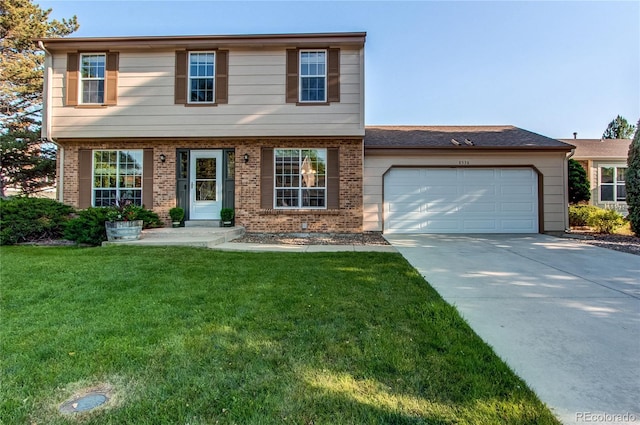 8538 W Glasgow Pl, Littleton, CO 80128 - view of front of property with a garage, driveway, a front yard, and brick siding