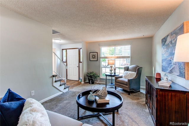 8538 W Glasgow Pl, Littleton, CO 80128 - living area featuring carpet floors, stairway, and a textured ceiling
