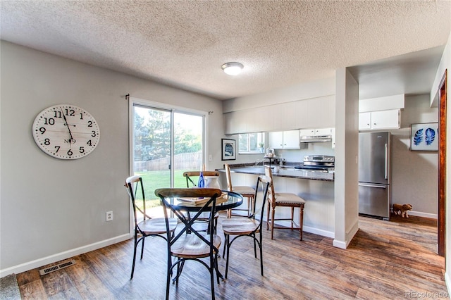 8538 W Glasgow Pl, Littleton, CO 80128 - dining area with a textured ceiling and wood finished floors