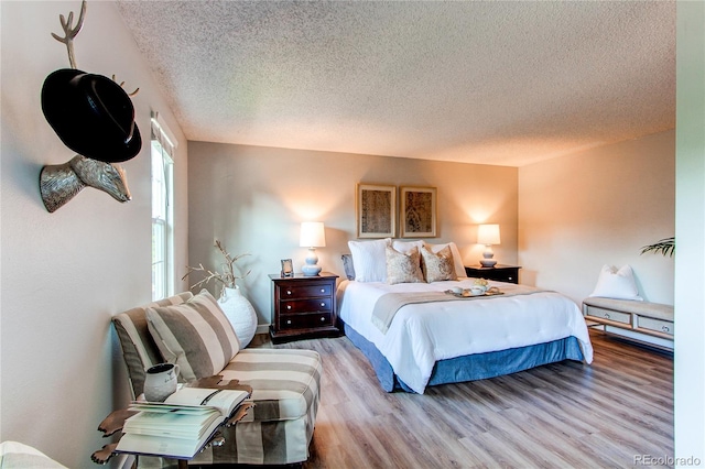 8538 W Glasgow Pl, Littleton, CO 80128 - bedroom with a textured ceiling and light wood finished floors