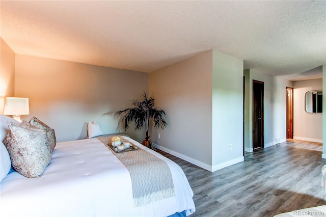 8538 W Glasgow Pl, Littleton, CO 80128 - bedroom with wood finished floors and a textured ceiling