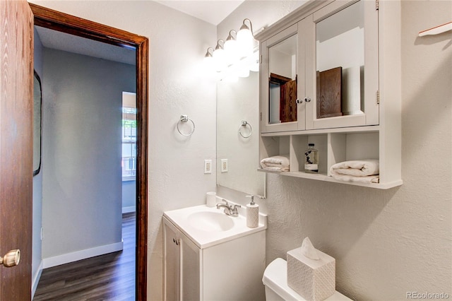 8538 W Glasgow Pl, Littleton, CO 80128 - half bath featuring wood finished floors, vanity, and a textured wall