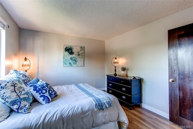 8538 W Glasgow Pl, Littleton, CO 80128 - bedroom featuring wood finished floors and a textured ceiling