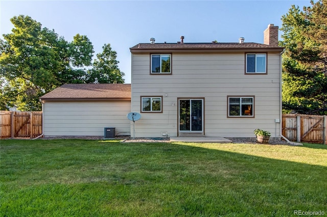 8538 W Glasgow Pl, Littleton, CO 80128 - back of house featuring a chimney, a fenced backyard, a patio area, and a gate