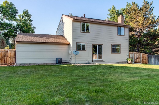 8538 W Glasgow Pl, Littleton, CO 80128 - rear view of house with a fenced backyard, a chimney, a gate, and a patio area