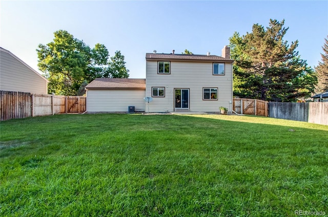 8538 W Glasgow Pl, Littleton, CO 80128 - rear view of property featuring a chimney and a fenced backyard