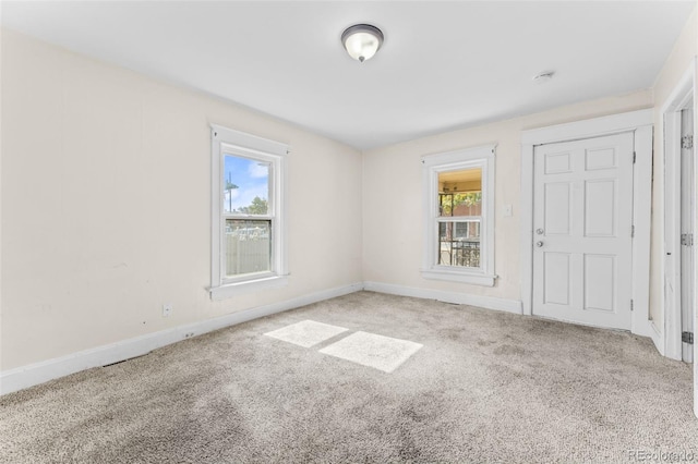 carpeted empty room featuring a healthy amount of sunlight