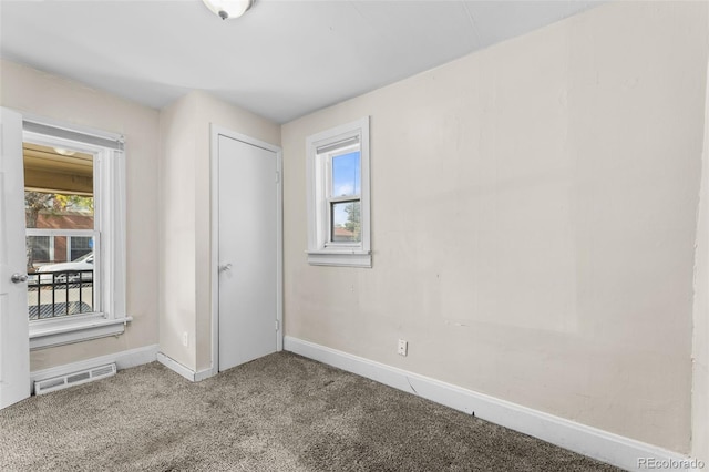 carpeted empty room featuring a healthy amount of sunlight