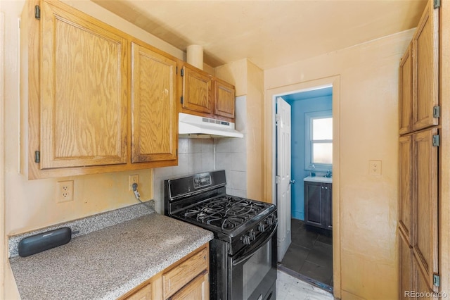 kitchen featuring black gas stove and tasteful backsplash