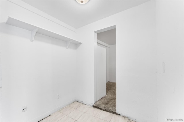 spacious closet featuring light carpet