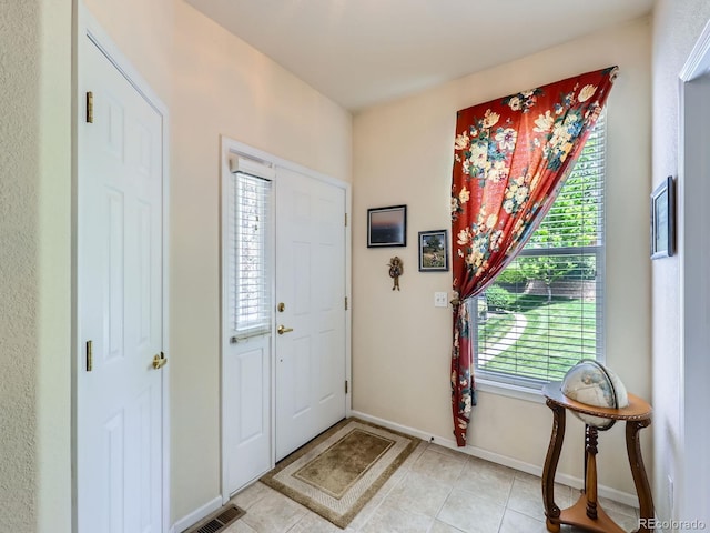 6626 S Reed Way Unit A, Littleton, CO 80123 - foyer entrance with light tile patterned flooring and baseboards