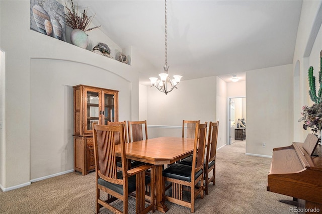 6626 S Reed Way Unit A, Littleton, CO 80123 - dining room with light colored carpet, a chandelier, and vaulted ceiling