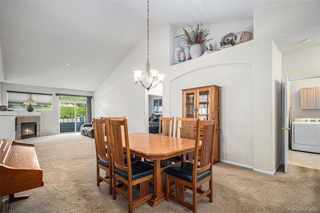 6626 S Reed Way Unit A, Littleton, CO 80123 - dining area with washer / clothes dryer, light colored carpet, a chandelier, high vaulted ceiling, and a lit fireplace