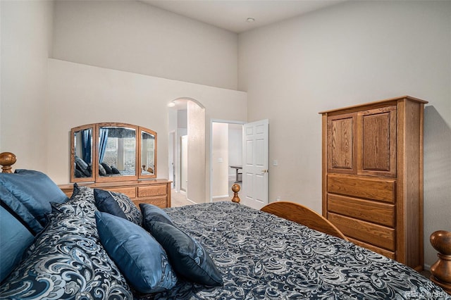 6626 S Reed Way Unit A, Littleton, CO 80123 - bedroom featuring a towering ceiling and arched walkways