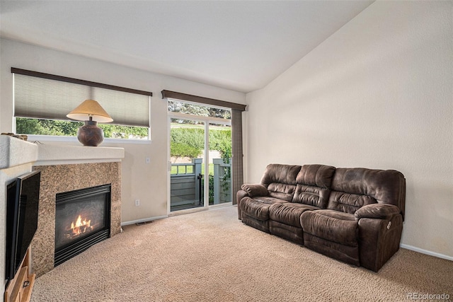 6626 S Reed Way Unit A, Littleton, CO 80123 - living area featuring carpet flooring, plenty of natural light, lofted ceiling, and a tiled fireplace