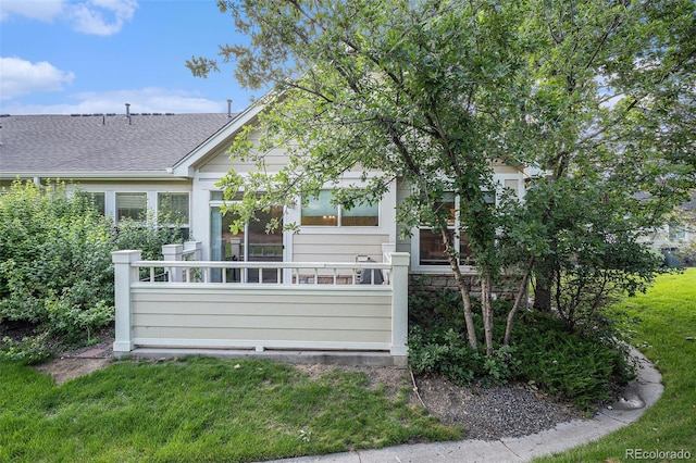 6626 S Reed Way Unit A, Littleton, CO 80123 - back of house featuring a shingled roof and a lawn