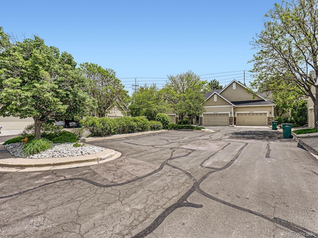 6626 S Reed Way Unit A, Littleton, CO 80123 - exterior space featuring an attached garage and driveway