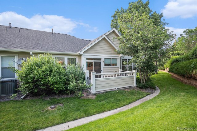 6626 S Reed Way Unit A, Littleton, CO 80123 - view of front of property featuring a front lawn and roof with shingles