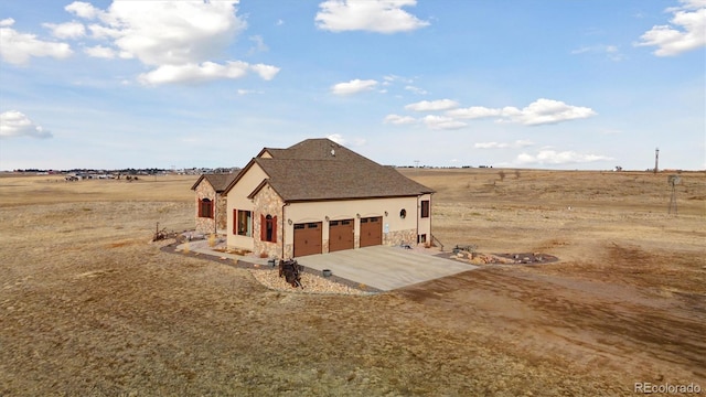 view of home's exterior featuring a rural view and a garage