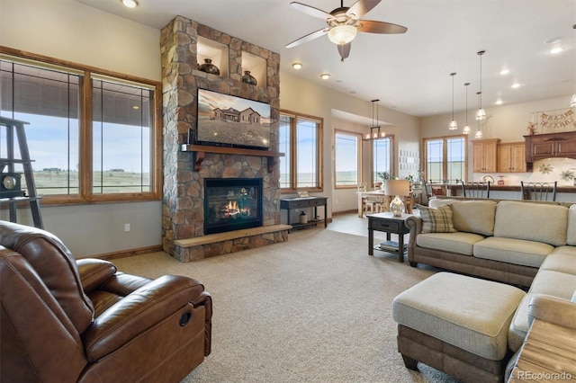 living room with light carpet, a fireplace, and ceiling fan