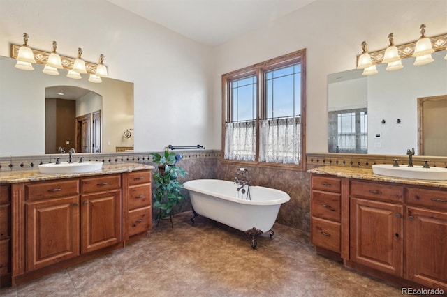 bathroom featuring vanity, a bathing tub, and tile walls