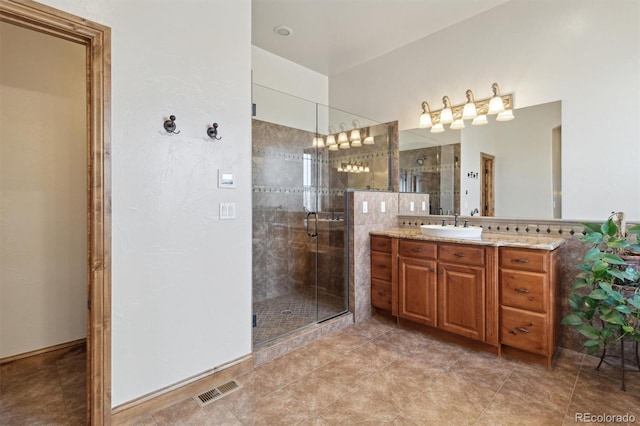 bathroom with walk in shower and vanity