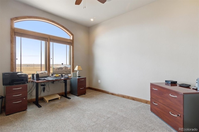 carpeted office space with ceiling fan