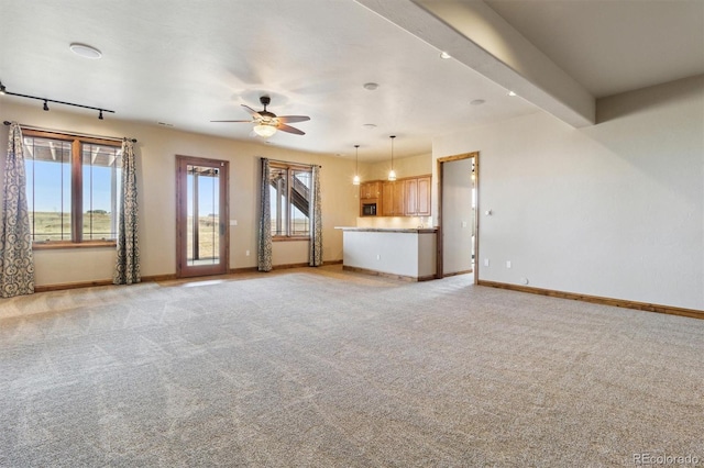 unfurnished living room with light colored carpet and ceiling fan