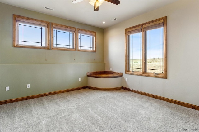 empty room with carpet flooring and ceiling fan