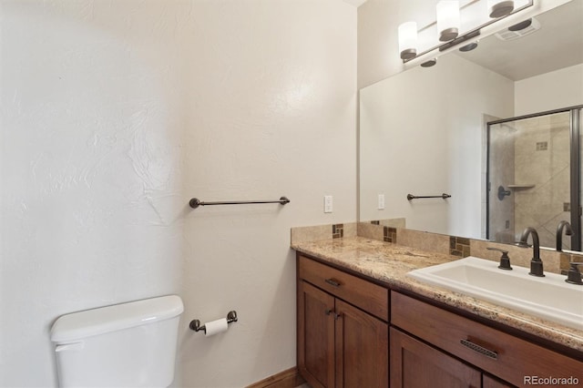 bathroom with vanity, toilet, and an enclosed shower