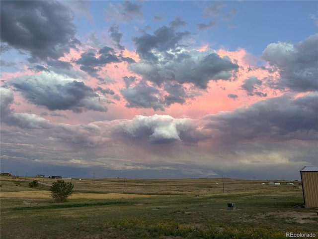 yard at dusk with a rural view