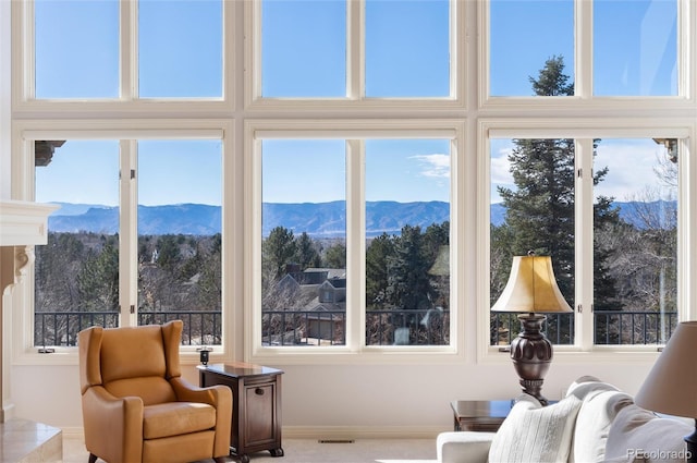 interior space with visible vents, a mountain view, and a healthy amount of sunlight