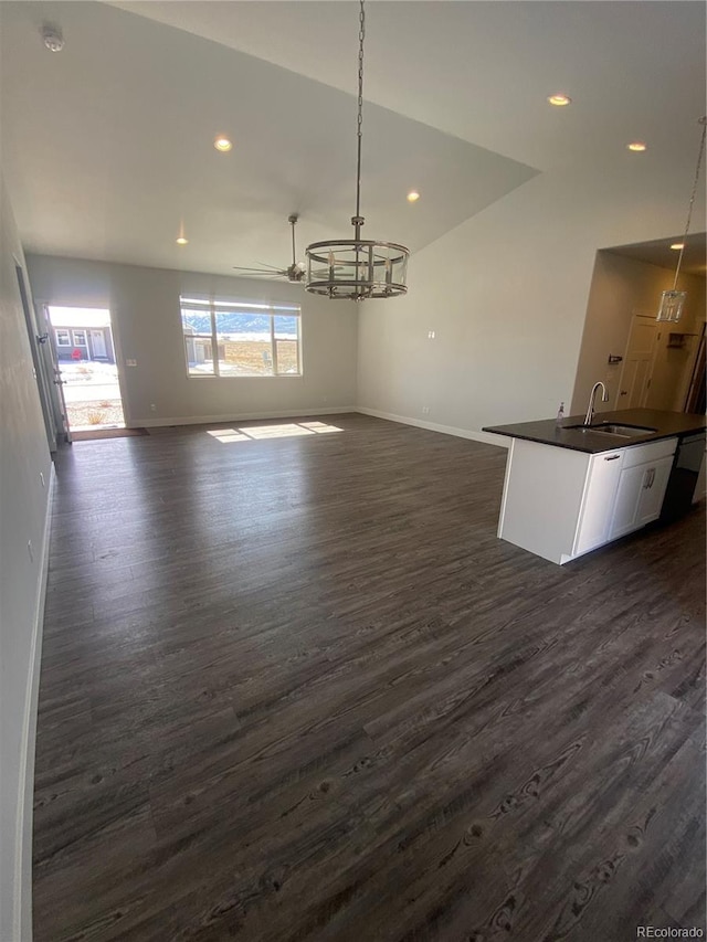 129 Red Tail Blvd, Buena Vista, CO 81211 - unfurnished dining area featuring a sink, baseboards, dark wood-type flooring, and recessed lighting