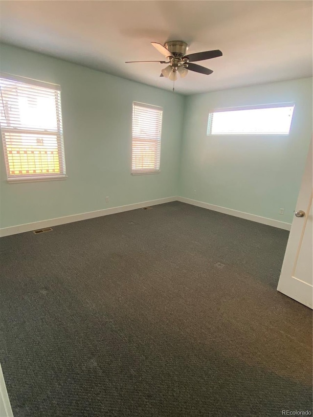 129 Red Tail Blvd, Buena Vista, CO 81211 - empty room with plenty of natural light, dark carpet, ceiling fan, and baseboards