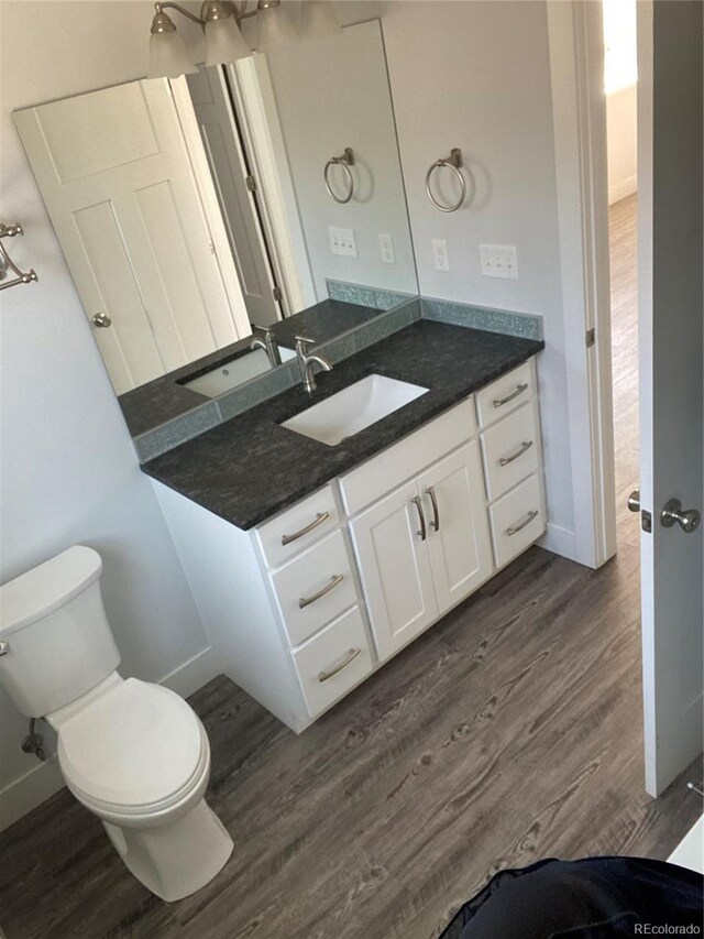 129 Red Tail Blvd, Buena Vista, CO 81211 - bathroom with wood finished floors, baseboards, toilet, and vanity