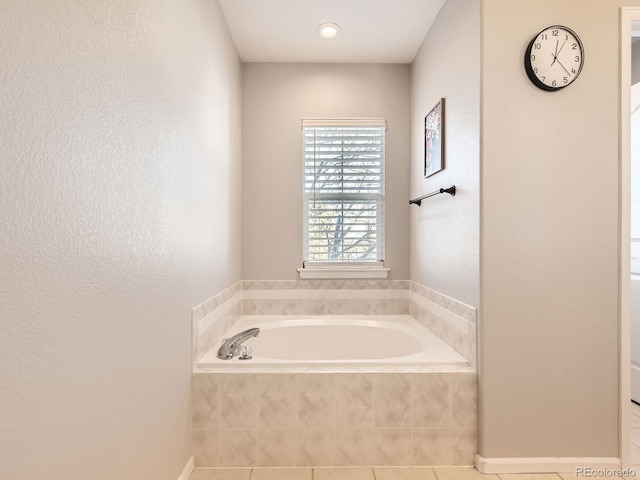 bathroom featuring tile patterned floors and tiled bath