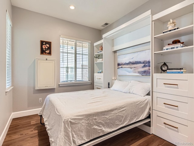 bedroom with dark hardwood / wood-style flooring