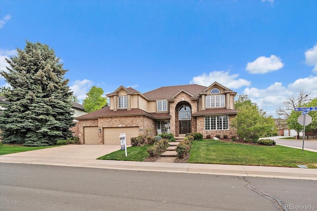 english style home with a garage, a front lawn, a shingled roof, brick siding, and driveway