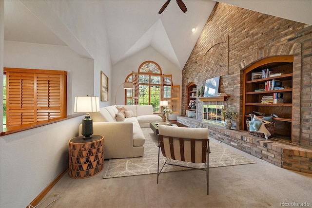 carpeted living area featuring ceiling fan, baseboards, high vaulted ceiling, built in features, and a brick fireplace