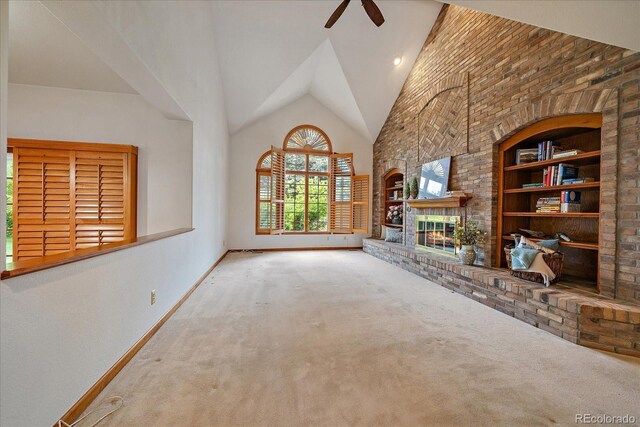 unfurnished living room with carpet flooring, baseboards, ceiling fan, high vaulted ceiling, and a fireplace