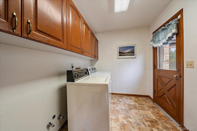 washroom with cabinet space, independent washer and dryer, baseboards, and stone finish flooring