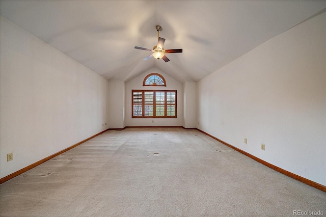 unfurnished room with a ceiling fan, baseboards, light carpet, and lofted ceiling