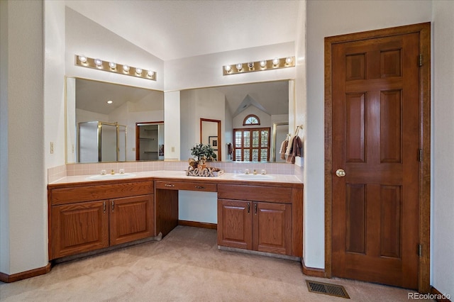bathroom featuring lofted ceiling, a stall shower, double vanity, and tasteful backsplash