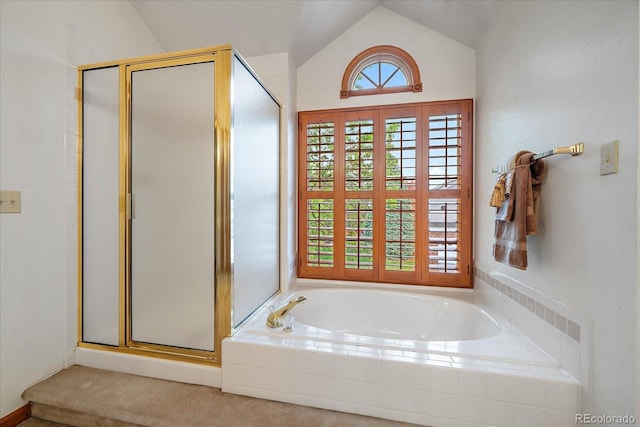 bathroom featuring a shower stall, a bath, and vaulted ceiling
